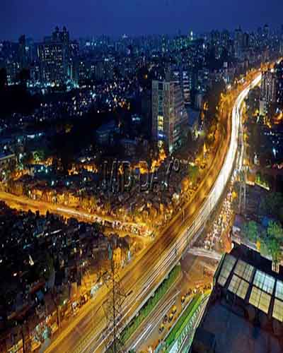 Aerial view of a city at night with a highway